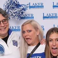 Group of three posing for camera in GVSU gear